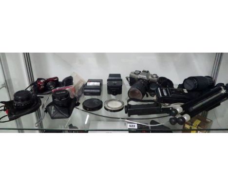 A Minolta XG-M SLR camera with various additional lenses, tripod and further automatic cameras.