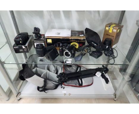 A Nikon SLR D60 camera 18.-55mm lens and another lens and tripod