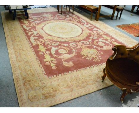 Savonerie design carpet, China, the field of scrolling acanthus centred by a roundel panel framed by leafy borders, 427 by 30