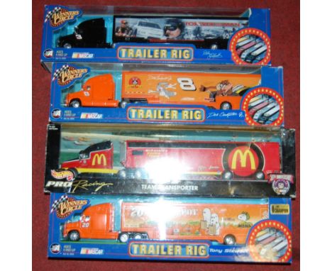 9 various boxed Nascar Winners Circles stock car and racing car trailer rig, boxed, tractor unit and trailers all in the orig