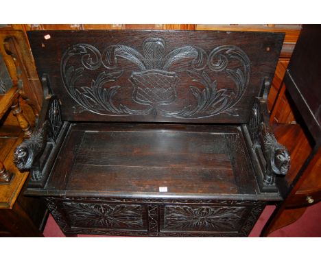 A circa 1900 line carved oak fold-over twin panelled monks bench, width 106.5cm
