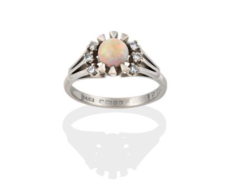 the round cabochon opal flanked by trios of eight-cut diamonds, in claw settings, to a tapered shoulder plain polished shank,