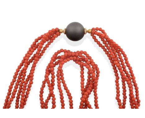 five intertwined rows of round coral beads, knotted to a polished onyx spherical clasp with round brilliant cut diamond detai