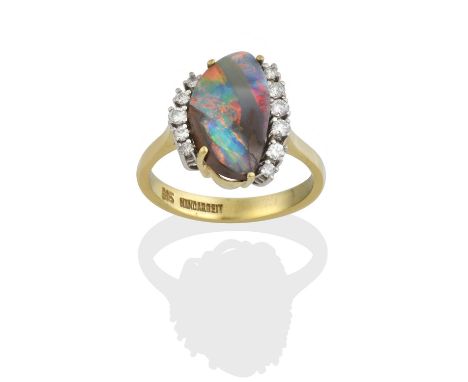 the irregular shaped opal matrix, in yellow claw settings, flanked by eight-cut diamonds, in white claw settings, to a yellow