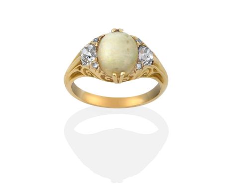 the oval cabochon opal flanked by cushion cut diamonds, with rose cut diamond accents, in yellow claw settings, with a scroll