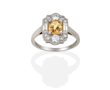 the emerald-cut yellow sapphire in a white claw setting, within a border composed of round brilliant cut and baguette cut dia