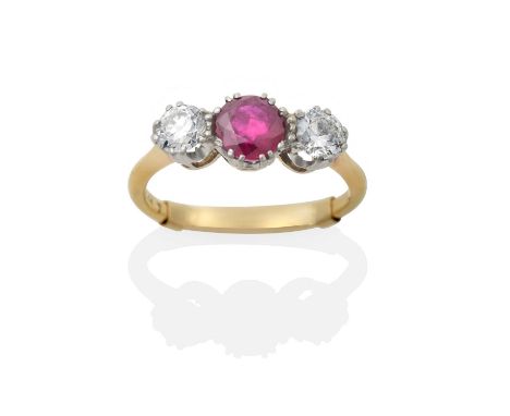 the round cut synthetic ruby flanked by round brilliant cut diamonds, in white claw settings, to a yellow tapered shoulder pl