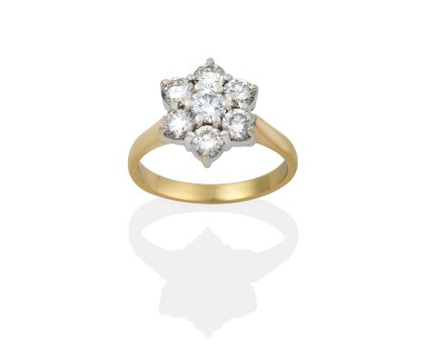 a round brilliant cut diamond within a border of round brilliant cut diamonds, in white claw settings, to a yellow tapered sh