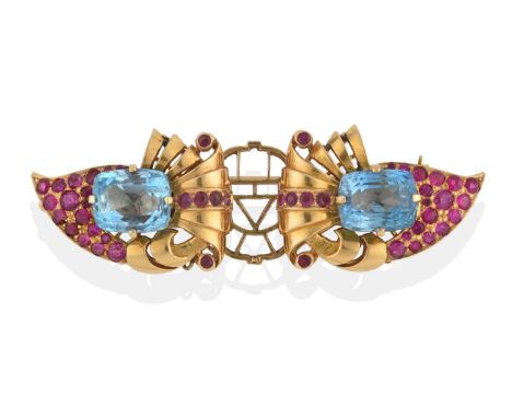 each clip of stylised foliate wing design, comprising a cushion shaped blue topaz and round cut synthetic rubies, in yellow c