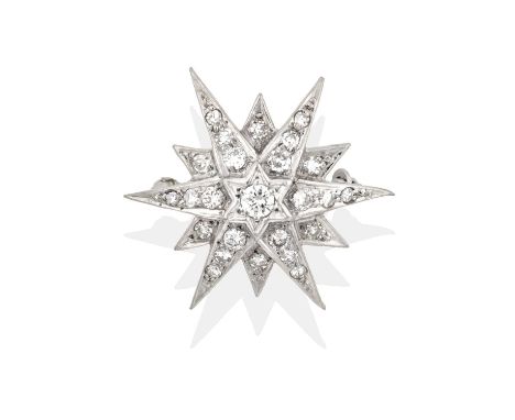 a round brilliant cut diamond centres twelve radial points, each set throughout with graduated round brilliant cut and eight-