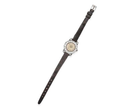 the circular golden dial with baton numerals within a frame of round brilliant cut diamonds, claw set with four similarly set