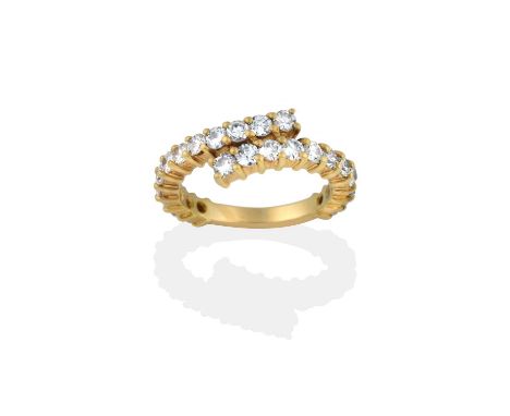 the round brilliant cut diamonds in yellow claw settings arranged in a twist formation, to a plain polished shank, total esti