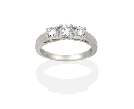 the graduated round brilliant cut diamonds in claw settings, to a tapered shoulder plain polished shank, total estimated diam