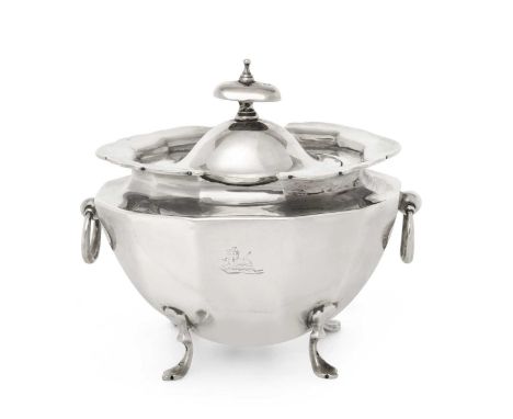 tapering oval and with facetted sides, on four pad feet and with drop ring handles. the hinged cover with oval finial, engrav