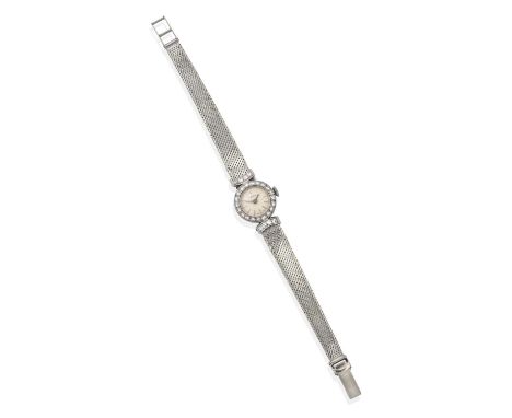 the circular cream dial with baton numerals, within a frame of eight-cut diamonds in millegrain settings, with similarly set 