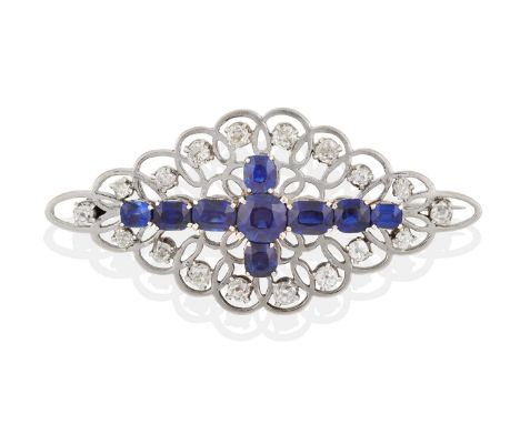 the vari-cut sapphires arranged in a cross formation, to a pierced border set throughout with old cut diamonds, in white claw