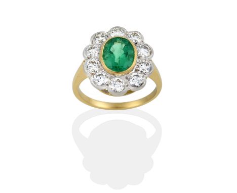 the oval cut emerald in a yellow rubbed over setting, within a border of round brilliant cut diamonds in white rubbed over se