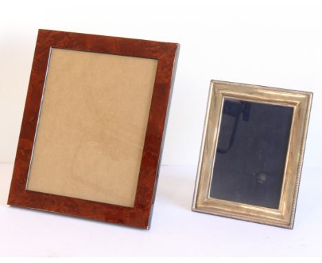 A modern silver photograph frame; beaded outer cushion-moulded frame and with wooden back with easel-style hinged stand (fram