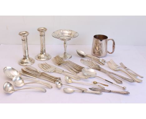 A pair of weighted silver candlesticks: Joseph Gloster Ltd., Birmingham, marks rubbed and date illegible, with gun barrel col