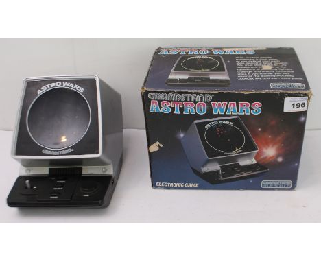 A boxed Grandstand Astro Wars table top video game, with (graffitied) instruction booklet and warranty card, not tested