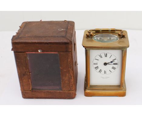An early 20th century carriage clock timepiece: white-enamel dial with Roman numerals and signed THOS. J. PORTE - WINNIPEG; l