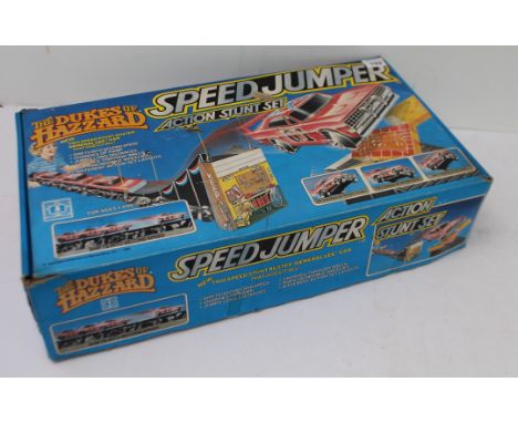 A boxed Hasbro The Dukes of Hazzard Speed Jumper Action Stunt Set: with friction drive two-speed Stunt Buster 'General Lee' c