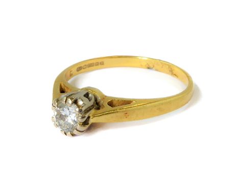 An 18-carat (marked 750) yellow gold dress ring set with a solitaire diamond within a pierced and pierced and white metal ope