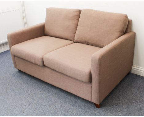 A modern two-seater sofa upholstered in&nbsp;light-coffee fabric and on short square tapering wooden legs (148 x 94 x 84 cm)