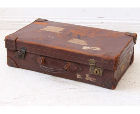 A vintage pre-war brown leather suitcase with brass lock fittings, the lid with stencilled initials 'AL', cream linen lining,