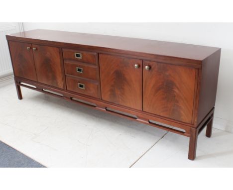 A large mid 20th century Grieves &amp; Thomas mahogany sideboard: three central graduated drawers with military style recesse