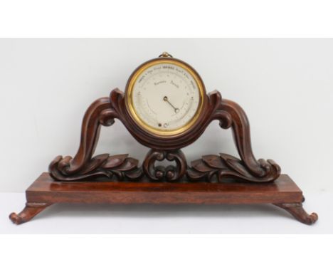A 19th century French&nbsp;aneroid barometer later mounted upon an early Victorian rosewood stand: the barometer above opposi