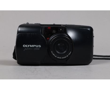 An Olympus mju Zoom Compact Camera, powers up, shutter fires, flash working, lug to bottom of battery door missing, door not 