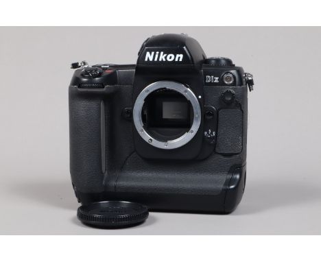 A Nikon D1x DSLR Camera Body, serial no 5015143, body G, light wear, with body cap, display screen cover, battery and charger