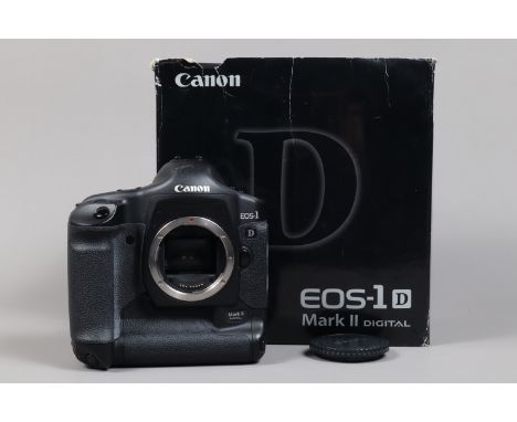 A Canon EOS-1D Mark II DSLR Camera Body, serial no 235595, body G, light wear, with body cap, AC adapter, DC coupler, battery