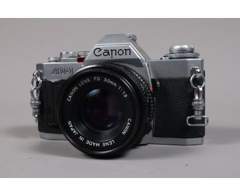 A Canon AV-1 SLR Camera, shutter working, meter responsive, self timer working, body G-VG, light wear, with Canon FD 50mm f/1