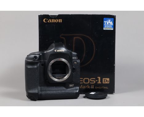 A Canon EOS-1 Ds Mark II DSLR Camera Body, serial no 327927, body G, some light wear, with body cap, strap, AC adapter, DC co