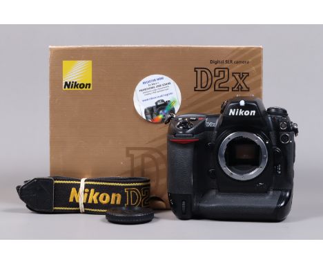 A Nikon D2x DSLR Camera Body, serial no 5041806, body G, some wear, with body cap, strap, manual, boxed focusing screen, batt