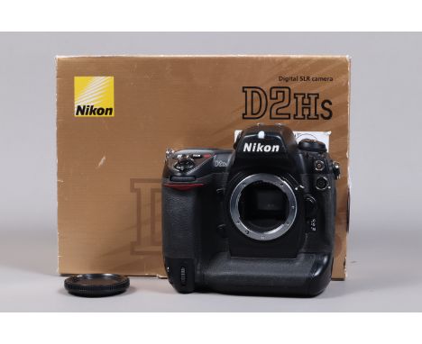 A Nikon D2Hs DSLR Camera Body, serial no 3007784, body G, some scratches to edges, with unbranded body cap, strap, manual, ba