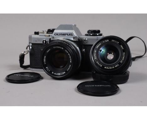 An Olympus OM10 SLR Body with Zuiko Lenses, serial no 2107469, body G, shutter working, meter reacts to light, a Zuiko Auto-S