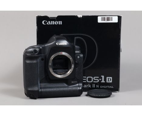 A Canon EOS-1D Mark II N DSLR Camera Body,   serial no 425759, body G, light wear, with body cap, strap, AC adapter, DC coupl