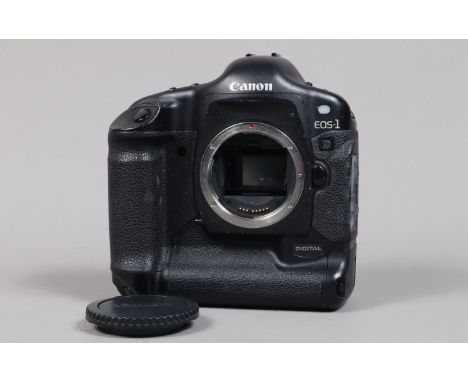 A Canon EOS-1 D DSLR Camera Body, serial no 015653, body G, some scratches to base, some wear to edges, with body cap, batter