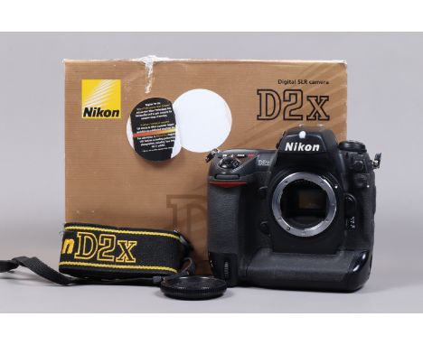 A Nikon D2x DSLR Camera Body, serial no 5070189, body G, light wear, with body cap, display screen cover, strap, manual, boxe