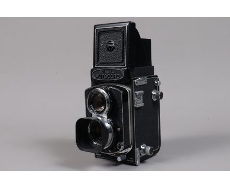 A Minolta Autocord RA TLR Camera, body G, G, light paint wear to edges, shutter working, self timer working, with Rokker 75mm