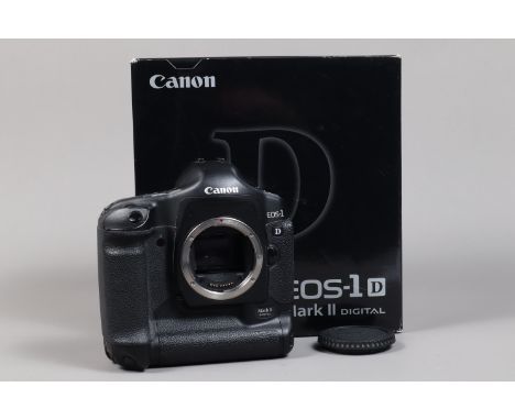 A Canon EOS-1D Mark II DSLR Camera Body, serial no 227730, body G, light wear, with body cap, AC adapter, DC coupler, battery