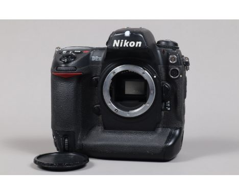 A Nikon D2H DSLR Camera body,  serial no 2014874, body G, some wear, with unbranded body cap, battery and MH-21 charger