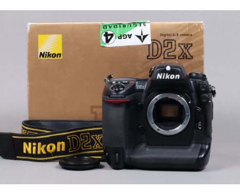 A Nikon D2x DSLR Camera Body, serial no 5043913, body G, light wear, with body cap, strap, manual, cables, battery, MH-21 cha