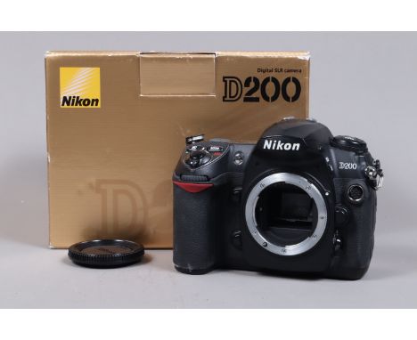 A Nikon D200 DSLR Camera Body, powers up, shutter working, body G, with charger, battery, manual, strap, in maker's box