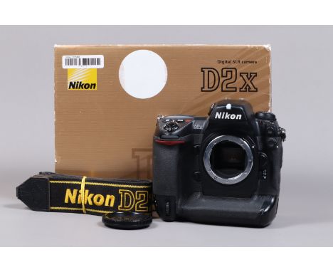 A Nikon D2x DSLR Camera Body, serial no 5075495, body G, some wear, missing leatherette from memory card cover, with body cap