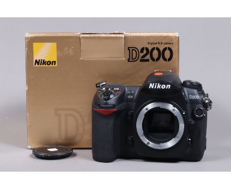 A Nikon D200 DSLR Camera Body, powers up, shutter working, body G, with charger, battery, strap, manual in maker's box