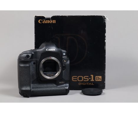 A Canon EOS-1 DS DSLR Camera Body, serial no 119984, body G, light wear, with body cap, strap, battery, charger, manual, in m